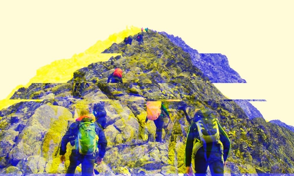 Group of people climbing a mountain