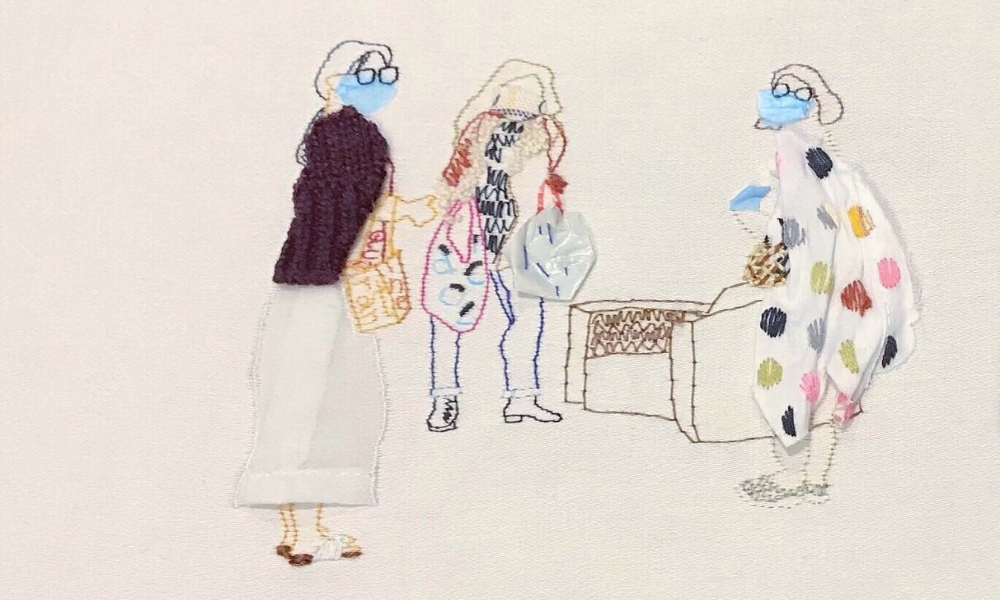 An illustration created with hand embroidery of three women wearing masks carrying shopping bags. 