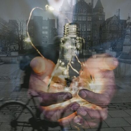 An image of hands offering a lightbulb superimposed on a photograph of George Square at the University of Edinburgh