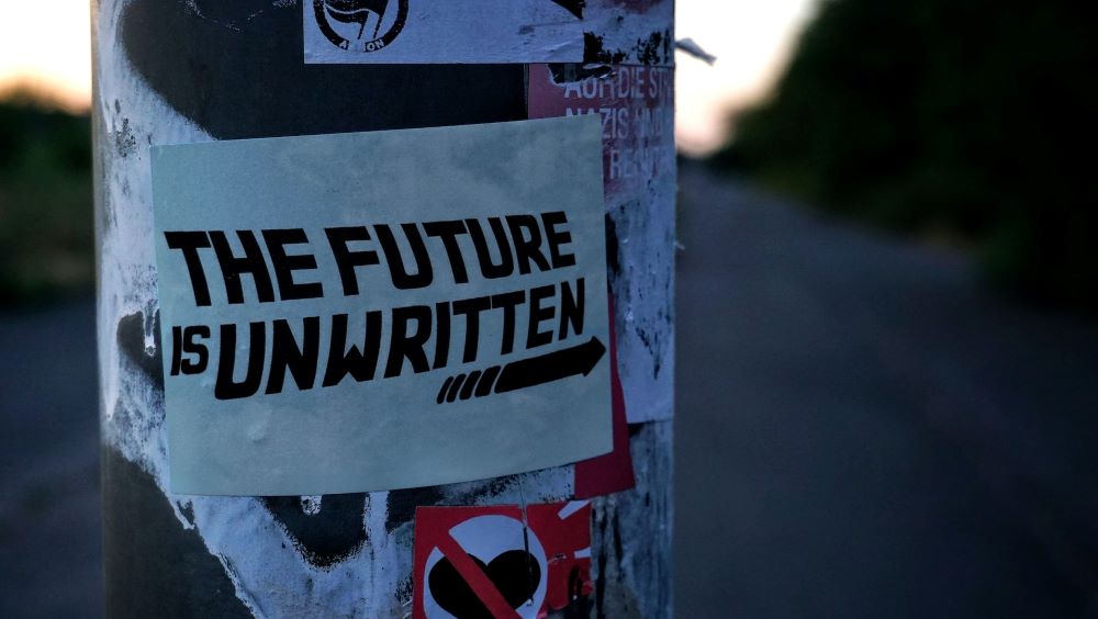 Sticker on post that says "The future is unwritten" decorative image
